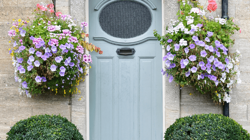 front door with hanging baskets