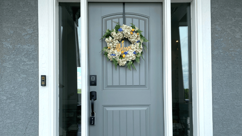 spring wreath hanging on a front door